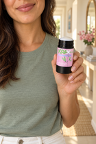 Person holding KAFX Bloom deodorant in an everyday setting