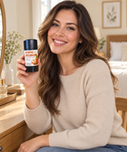 Person holding KAFX Caramel Core deodorant in an everyday setting