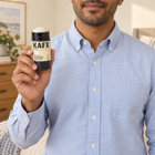 Person holding KAFX Naked deodorant in an everyday setting