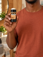 Person holding KAFX Palo Santo + Sandalwood deodorant in an everyday setting